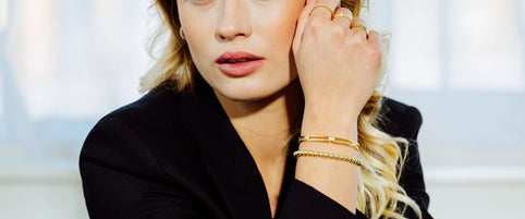 Loretana model black blazer portrait with sterling silver zirconia pendant, brief history of interchangeable jewelry. Hand-finished 925 silver Kaunas.