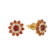 14K Gold Ruby Flower Studs in 925 sterling silver displayed on a white background showing their detailed red zirconia petals.