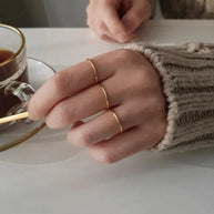 Close-up detail of the 14K gold-plated essential stacking band in 925 sterling silver showing the polished hallmarked finish, hand-finished in Kaunas.