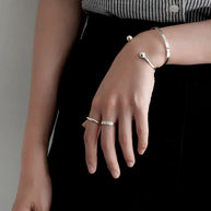 Woman wearing 925 silver personalized letter bangle as a minimalist statement piece
