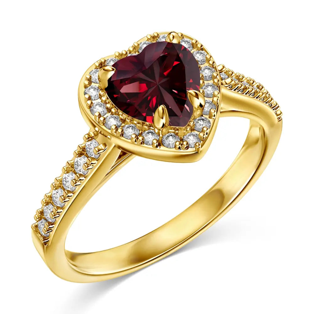 Hand model wearing the 14K gold plated red heart ring, showing the warm band and crimson heart stone. Hallmarked Loretana piece, hand-finished in Kaunas.