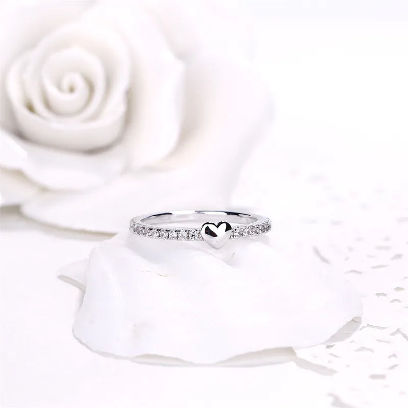 Front view of the rhodium plated 925 silver heart ring on white, showing the AAAAA heart cut zirconia solitaire. Hallmarked Loretana piece, hand-finished in Kaunas.