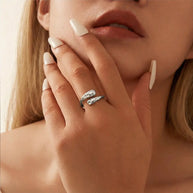 Macro detail of the silver hammered double teardrop ring showing the textured surface and rhodium-plated 925 sterling silver finish across both teardrop heads. Hallmarked Loretana piece, hand-finished in Kaunas.